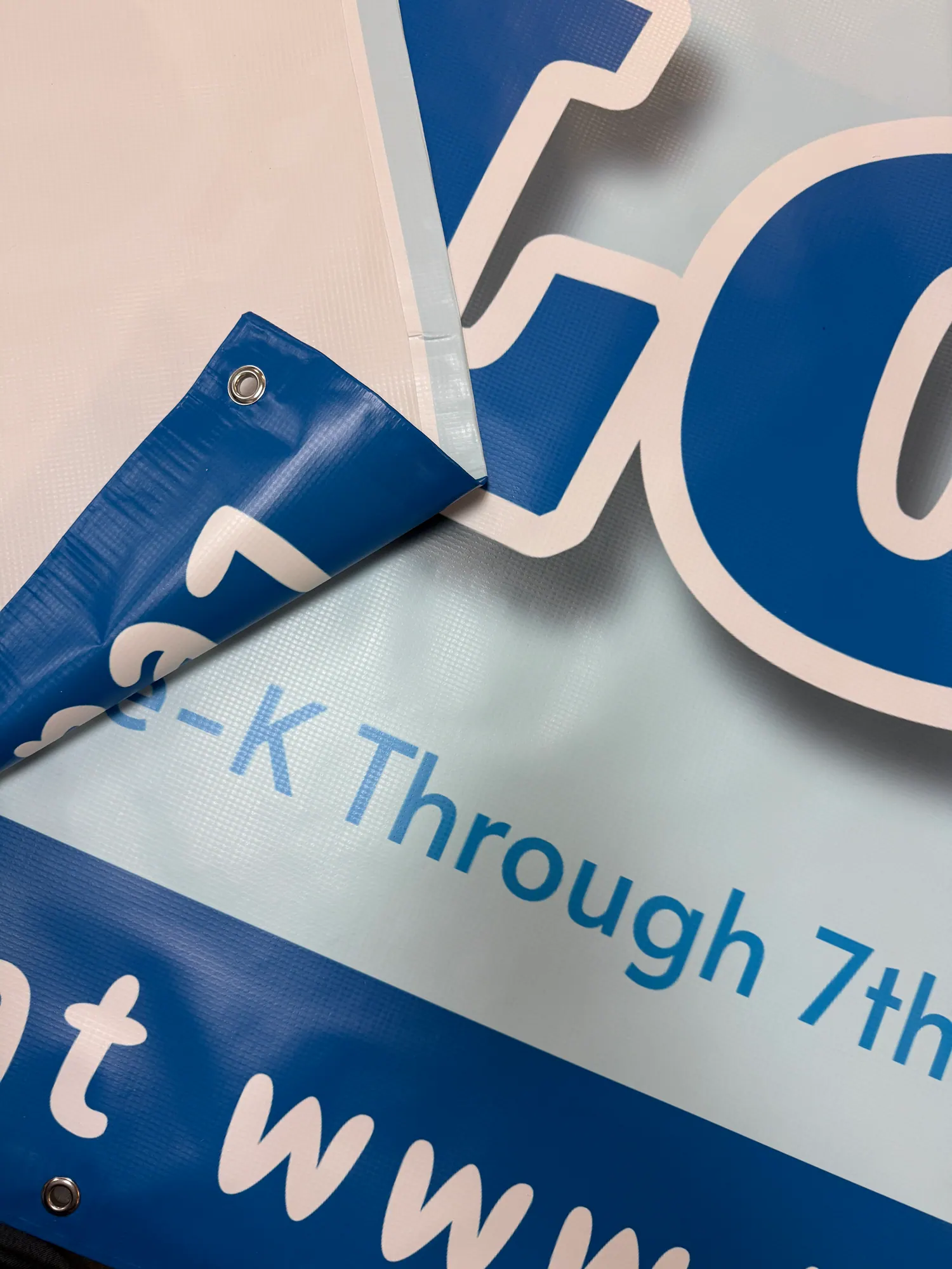 Printed custom banner material with blue and white graphics