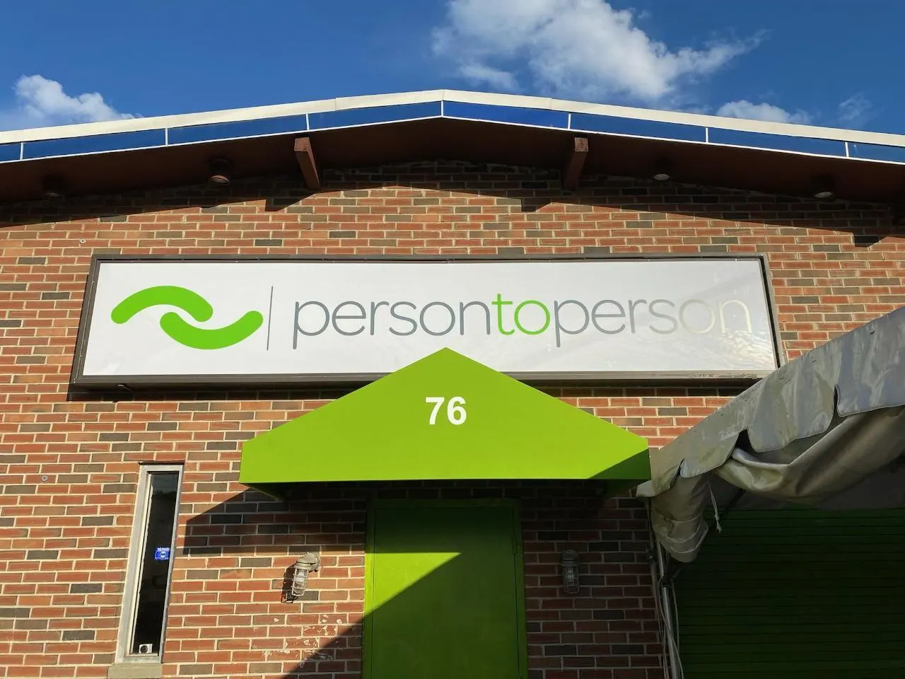 Exterior building sign installed on a brick storefront